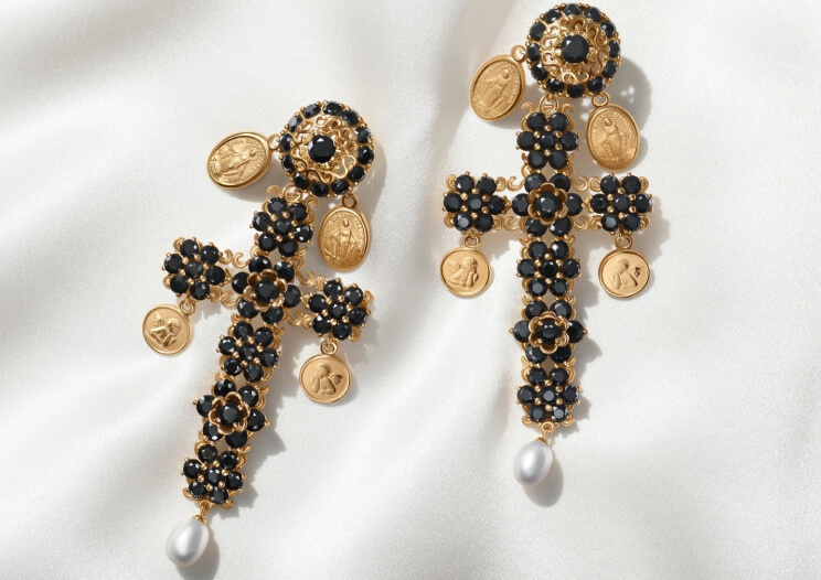 Dolce & Gabbana black flower cross earrings with gold medallions and pearl drops on white satin
