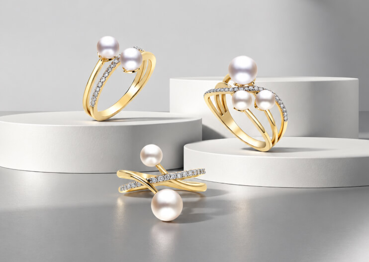 IMPERIAL Pearl gold rings set with pearls and diamonds on white display pedestals